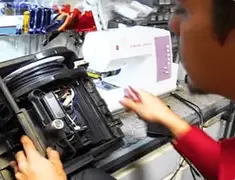 Vacuum repair technician servicing internal components on a workbench in Bradenton, FL