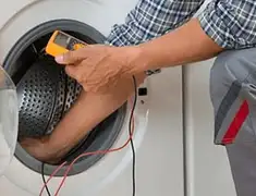 Washing machine repair technician testing a front-load washer with diagnostic tools in Bradenton, FL
